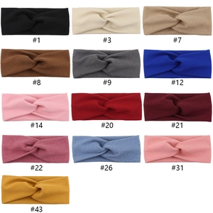 Collection of elastic cross knot headbands in 13 assorted solid colors for baby girls