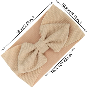 Elastic baby headband with large waffle fabric bow in beige color for infants