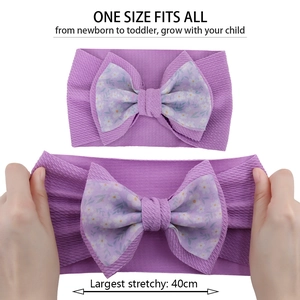 Close-up of stretchy lavender baby headband with a double-layered floral bow detail