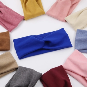 Knitted twist knot headbands for kids shown in multiple colors on a white background