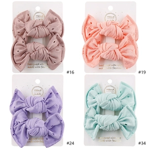 Set of four lace bow hair clips in pastel pink, purple, and green for baby girls