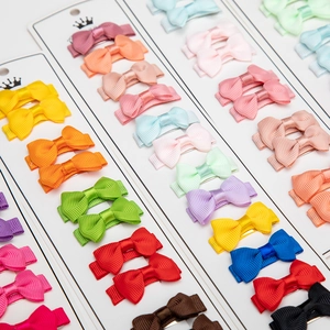 Colorful grosgrain ribbon bow hair clips set for girls displayed on a crown card