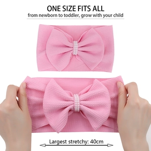 Pink waffle bow headband for infants featuring white pearl detail and 40cm elastic stretch