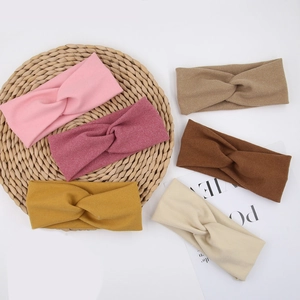 Detailed set of six soft elastic knotted baby headbands in various warm earthy colors