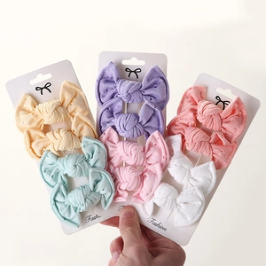 Detail of 6-color lace bow hair clips set with eyelet fabric texture on display card