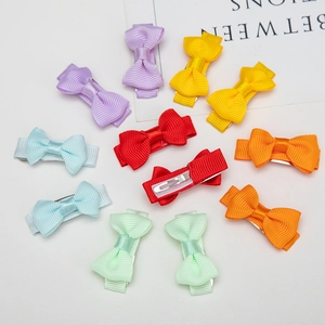 Flat lay of colorful grosgrain ribbon bow hair clips set with metal duckbill clips