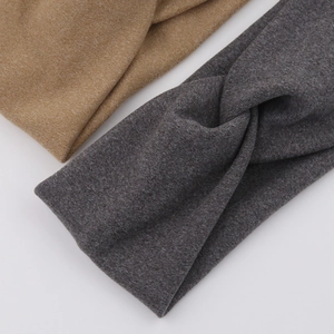 Detail of soft knitted cross twist headbands in dark grey and khaki colors