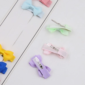Detail of colorful grosgrain ribbon bow hair clips with silver metal alligator clips