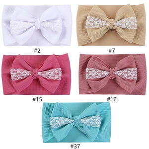 Set of baby headbands with large lace-decorated bows in five varied pastel colors