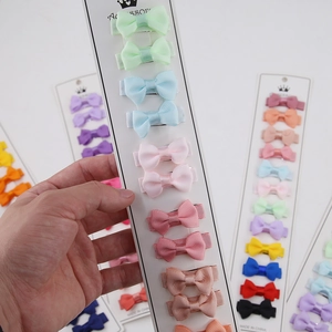Detail of grossgrain ribbon bow hair clips set for girls on a display card