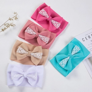 Detailed set of 5 waffle fabric baby headbands with large lace-trimmed bows in varied colors