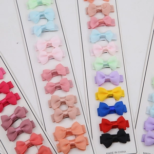 Detail view of multi-color grosgrain ribbon bow hair clips set on white display card