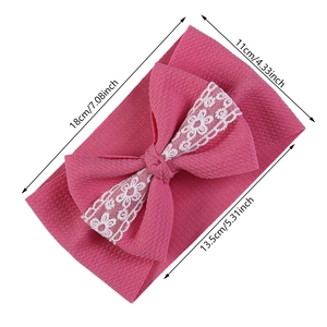 Pink elastic infant headband with large bow and white lace floral detail for baby girls