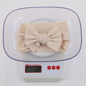 Elastic ribbed cotton baby headband with large bow in cream color weighing 22g