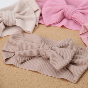 Detail showing the ribbed cotton texture and soft bow on the elastic baby headbands