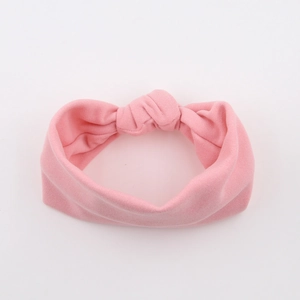 Detail of pink textured bubble fabric baby headband with a large decorative bow