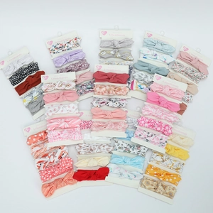Detail view of five-piece baby bow headband set with floral and polka dot patterns