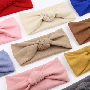 Detail showing various colors of soft knitted knotted headbands for infants and toddlers