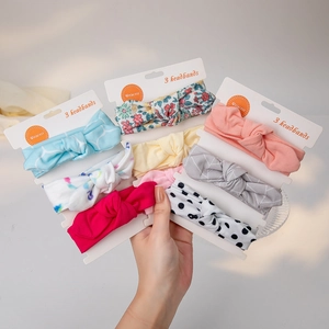Close-up of baby girl headband set with 3 pieces on card showing soft fabric knots