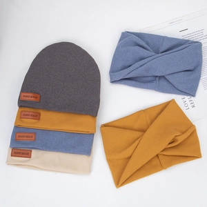 Close-up of baby knit beanies and twisted headbands in various colors for winter