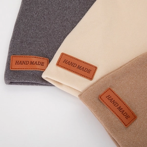 Detailed view of handmade soft cashmere knit baby hats in grey, beige and coffee colors