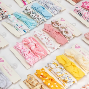 Five-piece set of baby girl bow headbands with floral, polka dot, and unicorn patterns
