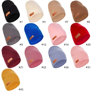 Knit baby beanie collection in 13 colors featuring a handmade leather patch detail