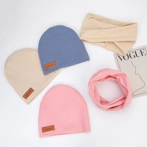 Knitted baby hat and scarf set in blue, pink, and beige with handmade leather tags