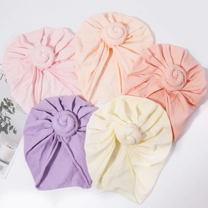 Five-pack of solid color cotton baby turban hats with stylish donut knot design for infants
