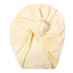Detailed close-up of light yellow knit baby turban showing soft texture and knot detail