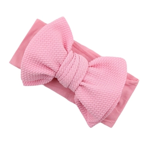 Roze zachte nylon babyhaarband met een grote wafelstructuur strik voor baby's