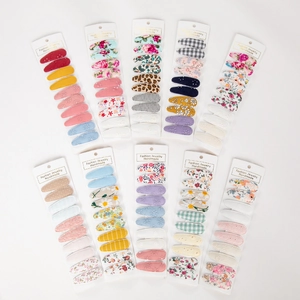 Detail view of 100-piece floral and solid fabric covered BB hair clips on cards