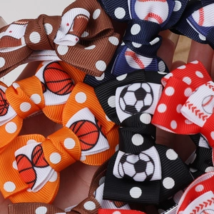 Detail showing various sports themed ribbon bow clips featuring football and basketball patterns