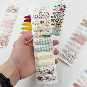 Detailed set of handmade fabric hair clips featuring floral prints and embroidery