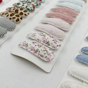 Detail view of 10-piece floral and leopard print fabric covered snap hair clips set