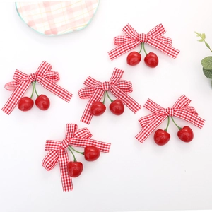 Detailed close-up of 5-piece cherry hair clip set with red and white plaid bows