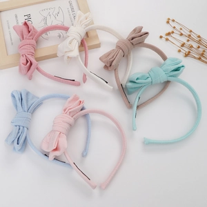 Detailed top view of six striped cotton bow headbands in soft pastel colors for girls
