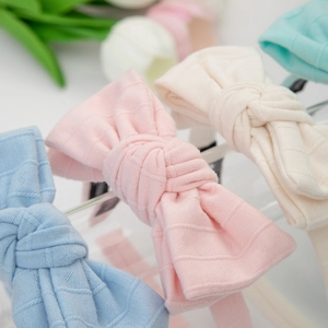 Pastel knitted bow headbands for girls with hollow heart patterns and ribbed texture