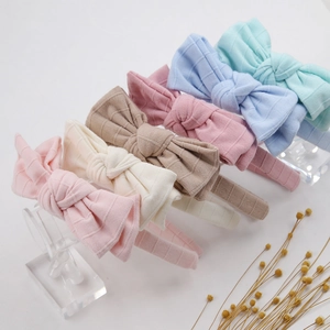 Detailed set of six colorful waffle knit bow headbands for infants in varied pastel tones