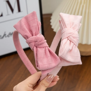 Detail of pink cotton bow headbands with heart textured fabric for little girls