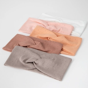 Close-up of five knitted elastic yoga headbands with knot detail and hollow-out texture