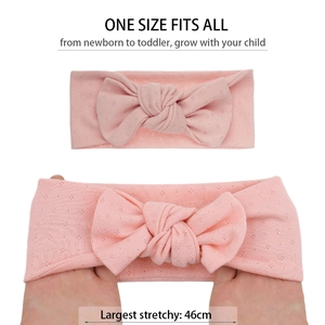 Pink organic cotton baby headband with bow showing stretchable fit up to 46cm