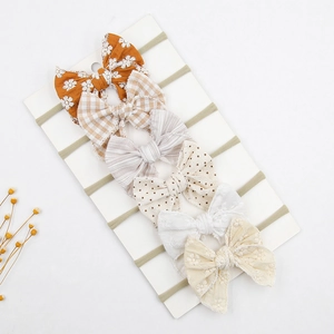 Set of 6 assorted floral and checkered baby bow headbands on high-elastic nylon bands