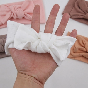 Detail of soft ribbed organic cotton baby headband with bow in various pastel colors