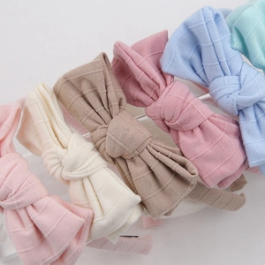 Detail of macaron-colored bow headbands with knit heart texture and ribbed jacquard fabric
