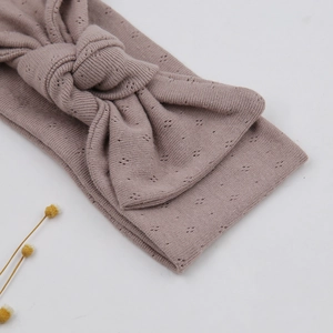 Detailed macro view of baby bow headband with elegant diamond hollow knit patterns