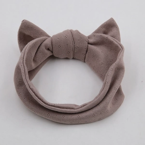 Breathable dusty pink organic cotton baby headband with a large bow for toddlers
