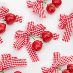Cute cherry bow hair clips for girls featuring red gingham pattern on white background