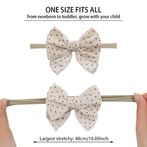 Detail showing elastic nylon headband stretchable up to 48cm with embroidered bow