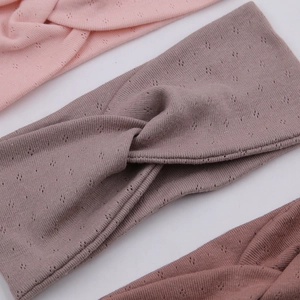 Detail of cross-knot yoga headbands showing breathable diamond-knit cotton texture